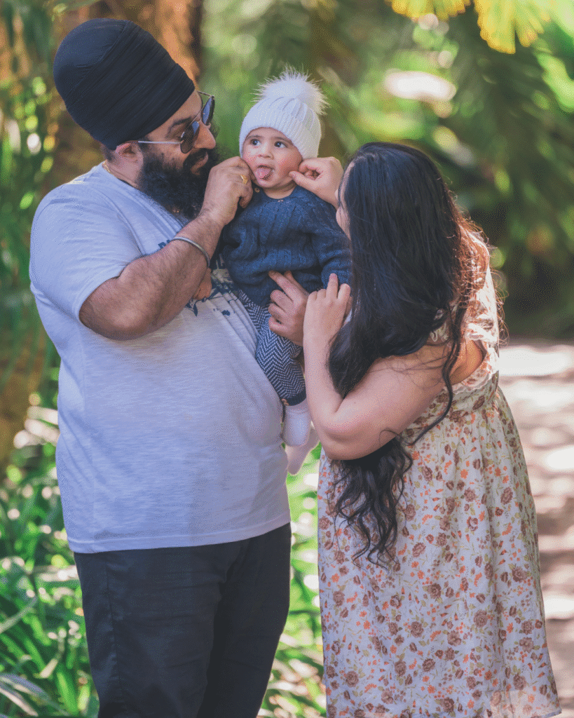 family of 3 smiling during family photoshoot in the parklands sydney